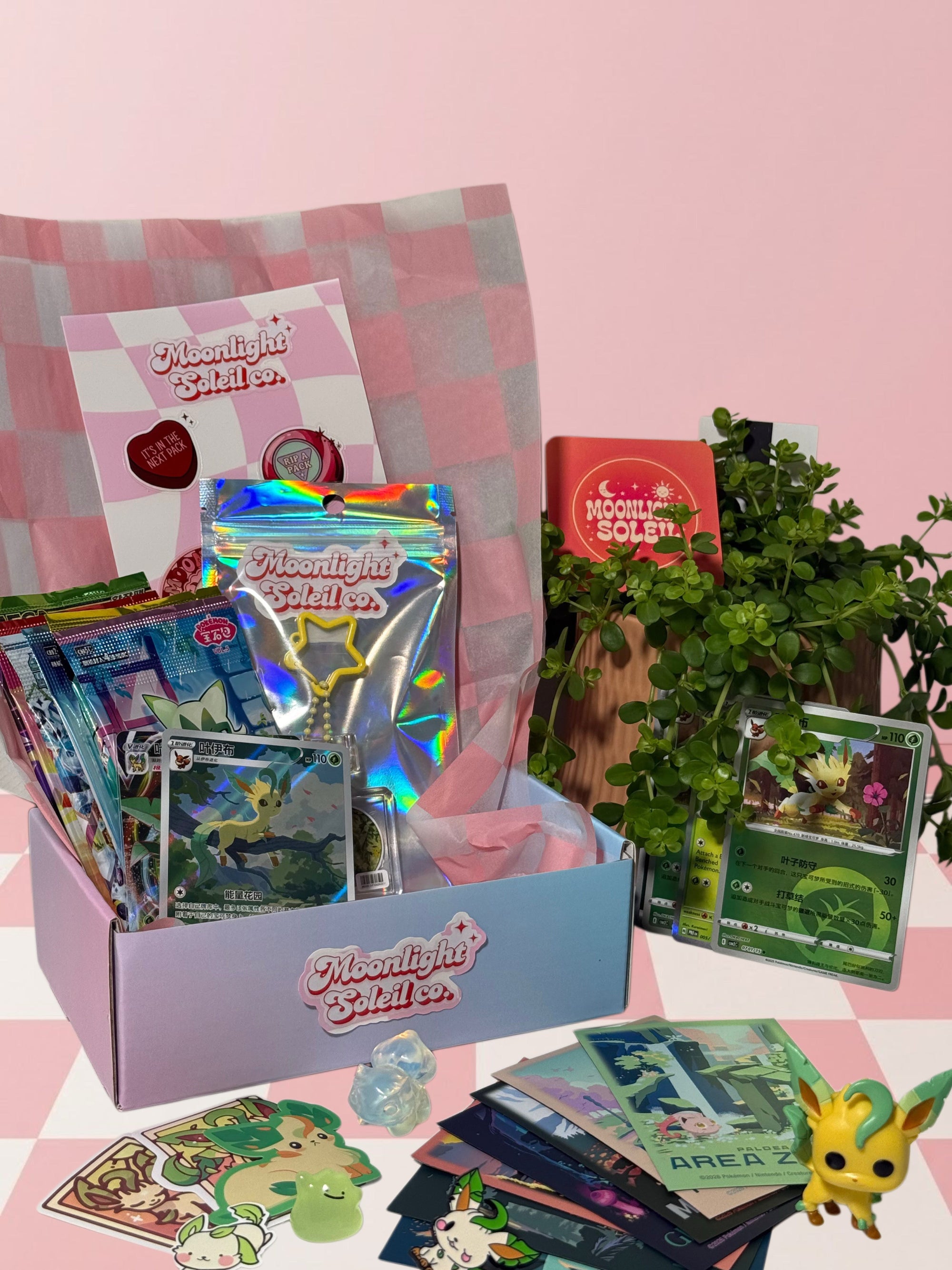 Moonlight Soleil curated Pokemon gift box, a Leafeon themed example with booster packs, a premium single, sticker sheets and a collectible figure